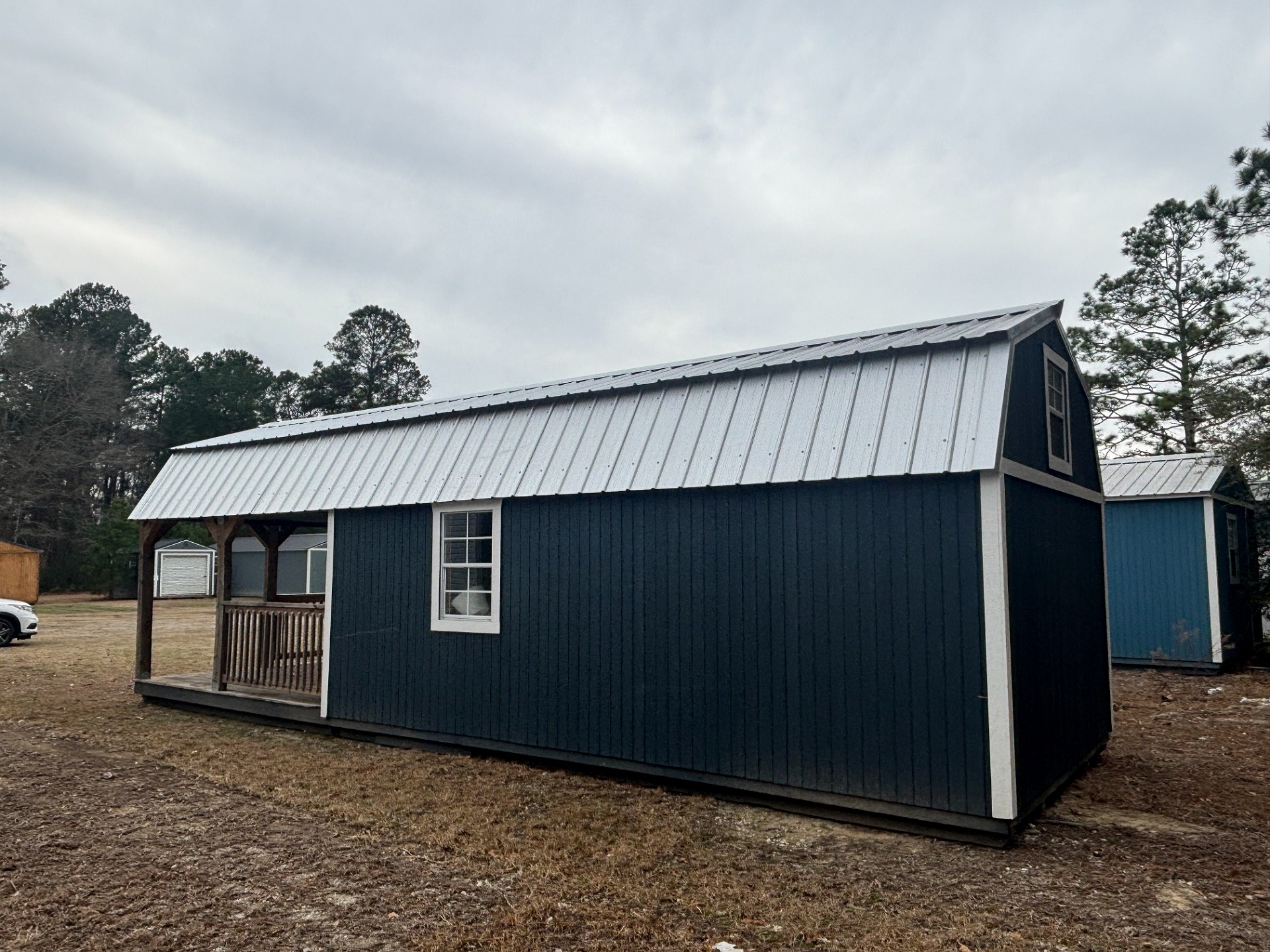12x32 Wrap Around Porch Lofted Barn Cabin at Portable Buildings of Ravenel