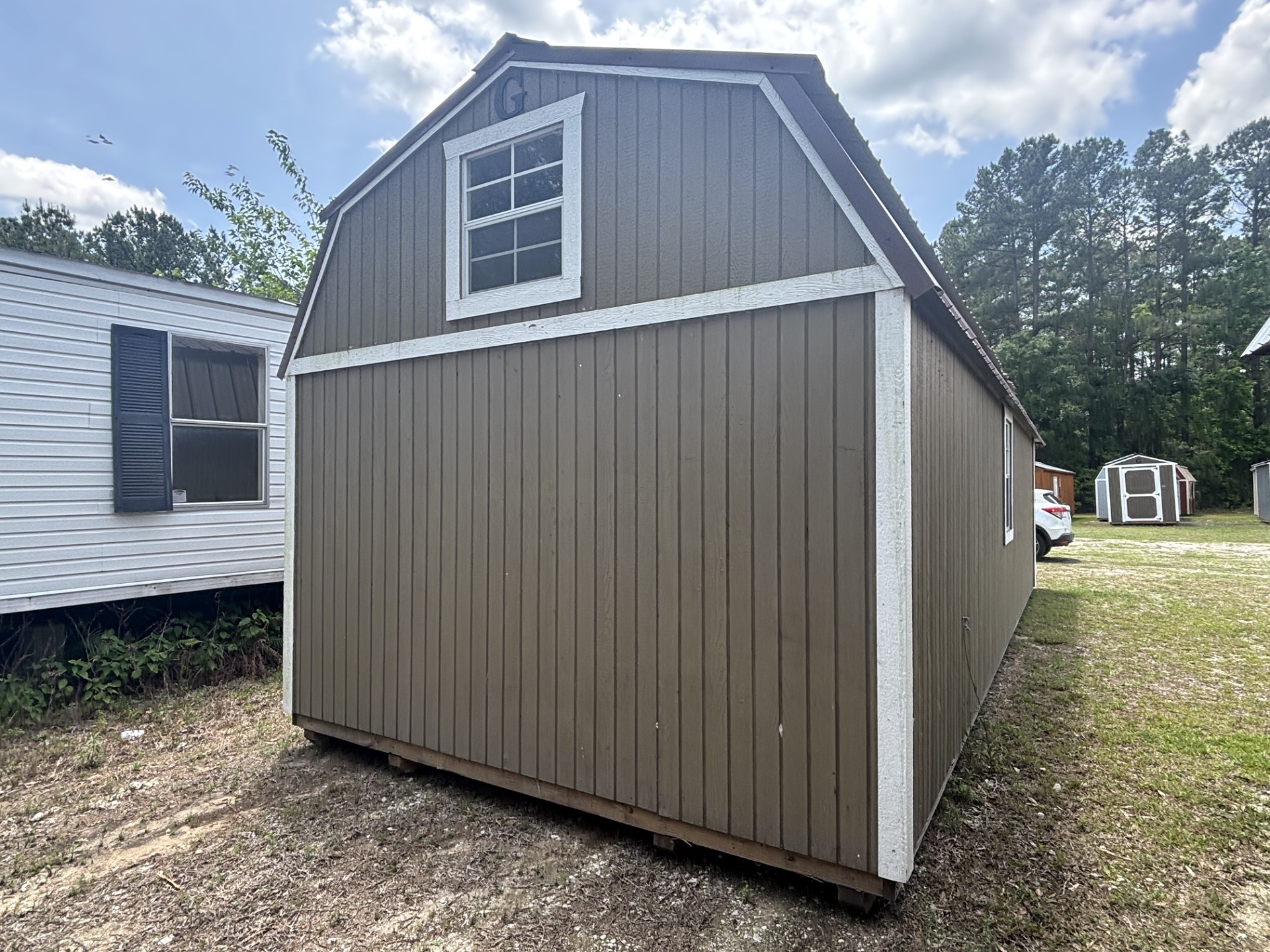 12x32 Wrap Around Porch Lofted Barn Cabin at Portable Buildings of Ravenel
