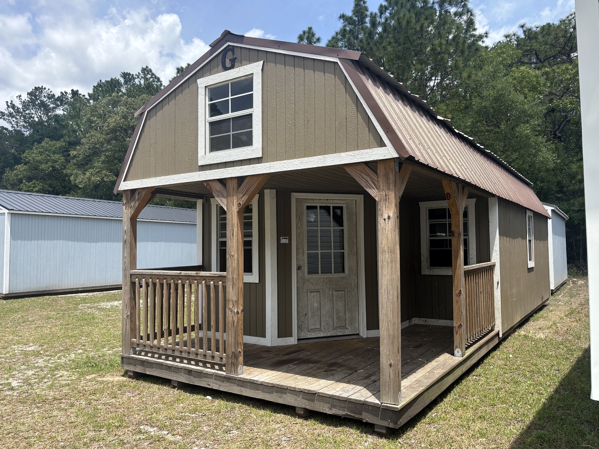 12x32 Wrap Around Porch Lofted Barn Cabin at Portable Buildings of Ravenel