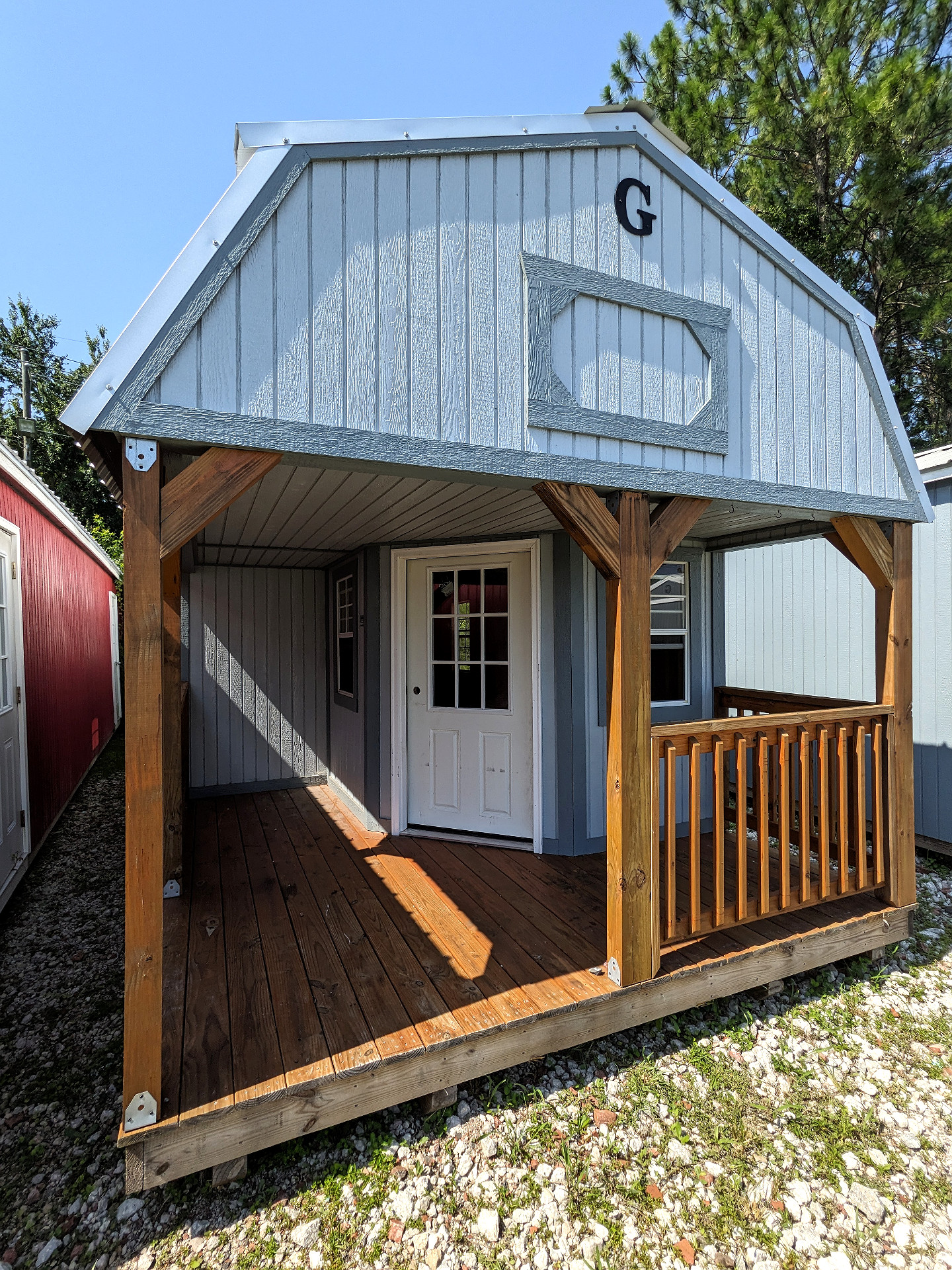 12x32 Wrap Around Porch Lofted Barn Cabin at Graceland Storage Sheds and Buildings of Kingsland