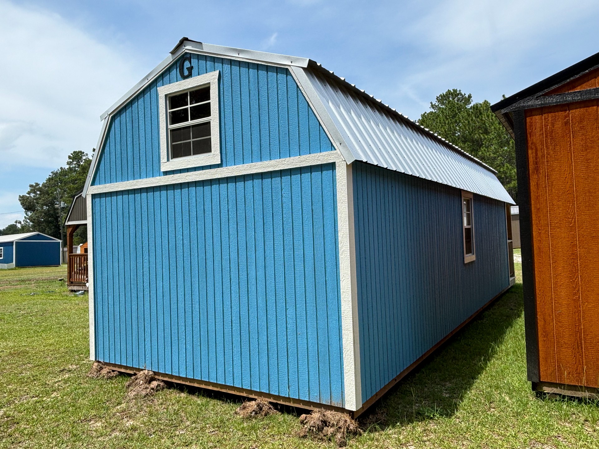 12x32 Wrap Around Porch Lofted Barn Cabin at Portable Buildings of Ravenel