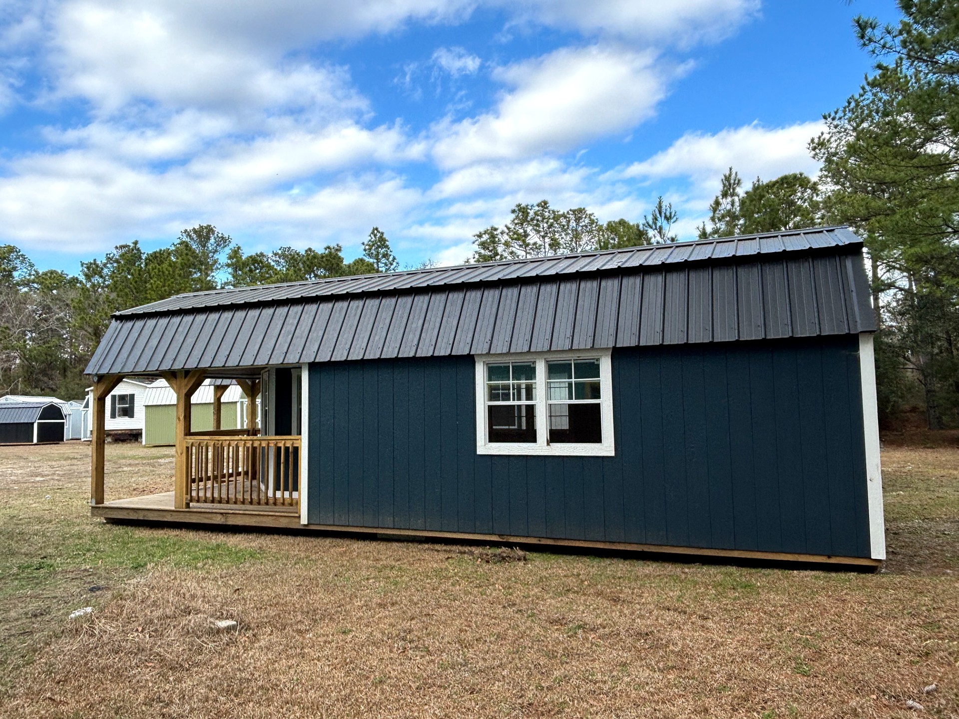 12x32 Wrap Around Porch Lofted Barn Cabin at Portable Buildings of Ravenel