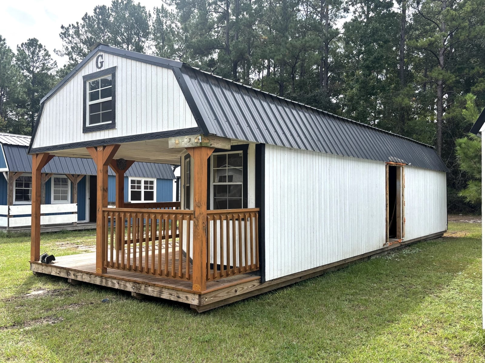 14x40 Wrap Around Porch Lofted Barn Cabin at Portable Buildings of Ravenel